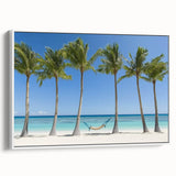 Framed canvas artwork depicting a serene beach landscape with vibrant blue skies and soft white sands, showcasing a modern, minimalist white frame for elegant decor. Perfect for coastal-themed interiors.