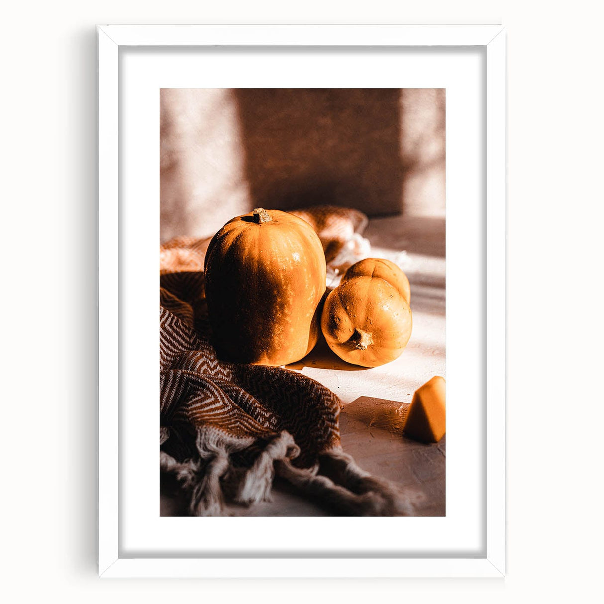 Abstract art print featuring swirling autumnal hues on a white framed canvas, suitable for bedroom or dining room decor.