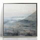 Framed acrylic wall art depicting abstract landscapes in silver tones, showcasing fluid forms and modern design for contemporary home decor.