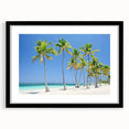 Black-framed landscape artwork depicting a serene beach scene, featuring soft waves and golden sand, designed to enhance interior decor and evoke tranquility.