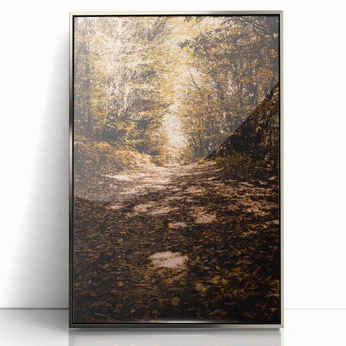 Mid-century modernist art depicting autumn trees in warm orange and yellow tones, framed in silver acrylic.