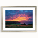 Framed landscape artwork showcasing dramatic cliffs under a clear blue sky, highlighted by a sleek silver mat, perfect for modern home decor and nature lovers.