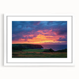 Framed landscape artwork depicting rugged cliffs under a bright blue sky, featuring a white mat for an elegant presentation, ideal for home decor enhancement.