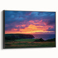Framed canvas artwork showcasing a dramatic landscape of cliffs, with a sleek black frame accentuating the vibrant colors of the scene, perfect for modern home decor.