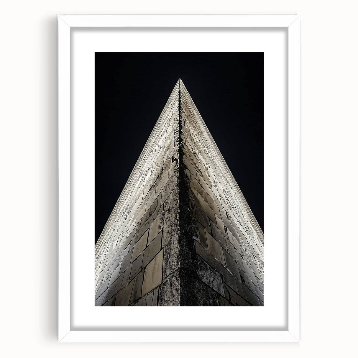Abstract art print featuring geometric shapes in muted gray and blue tones, framed with a white mat.