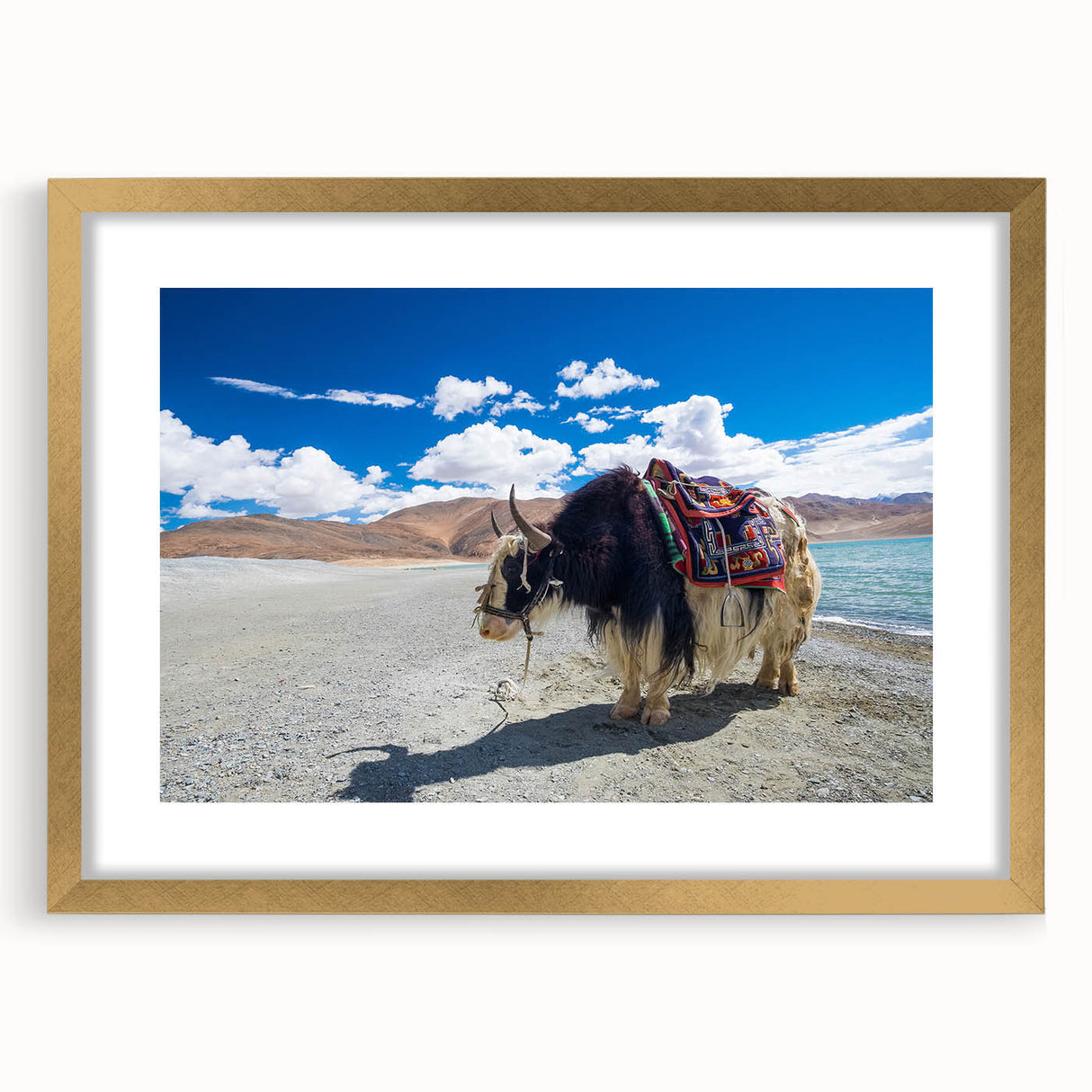 Extra large abstract art print featuring textured scenery of Tibet in muted earth tones, framed in gold.