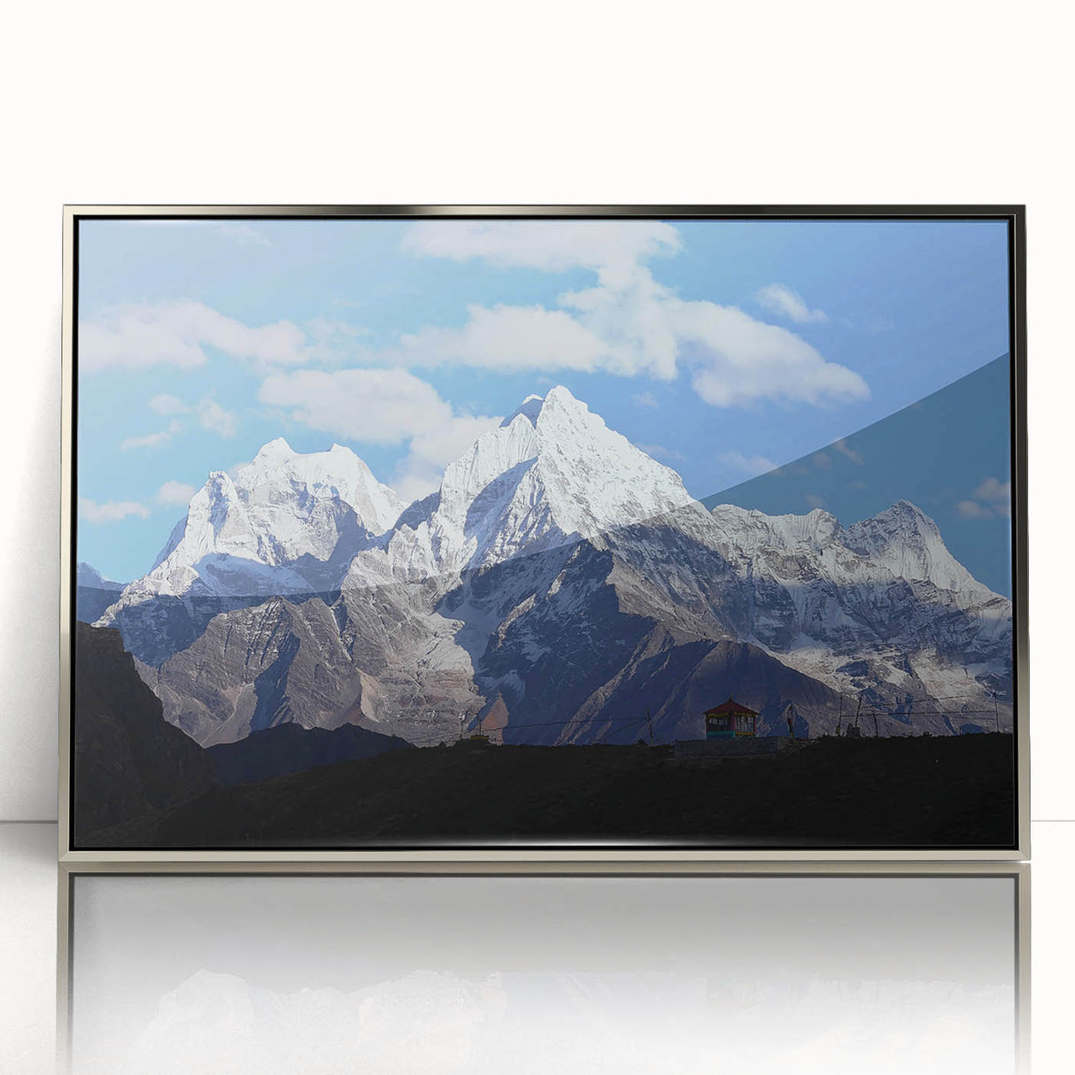 Mid-century modernist art depicting a serene Nepalese landscape in muted earth tones on a silver-framed acrylic.