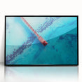 Large abstract wall art depicting Caribbean scenery in muted blue and green tones, framed in black acrylic.