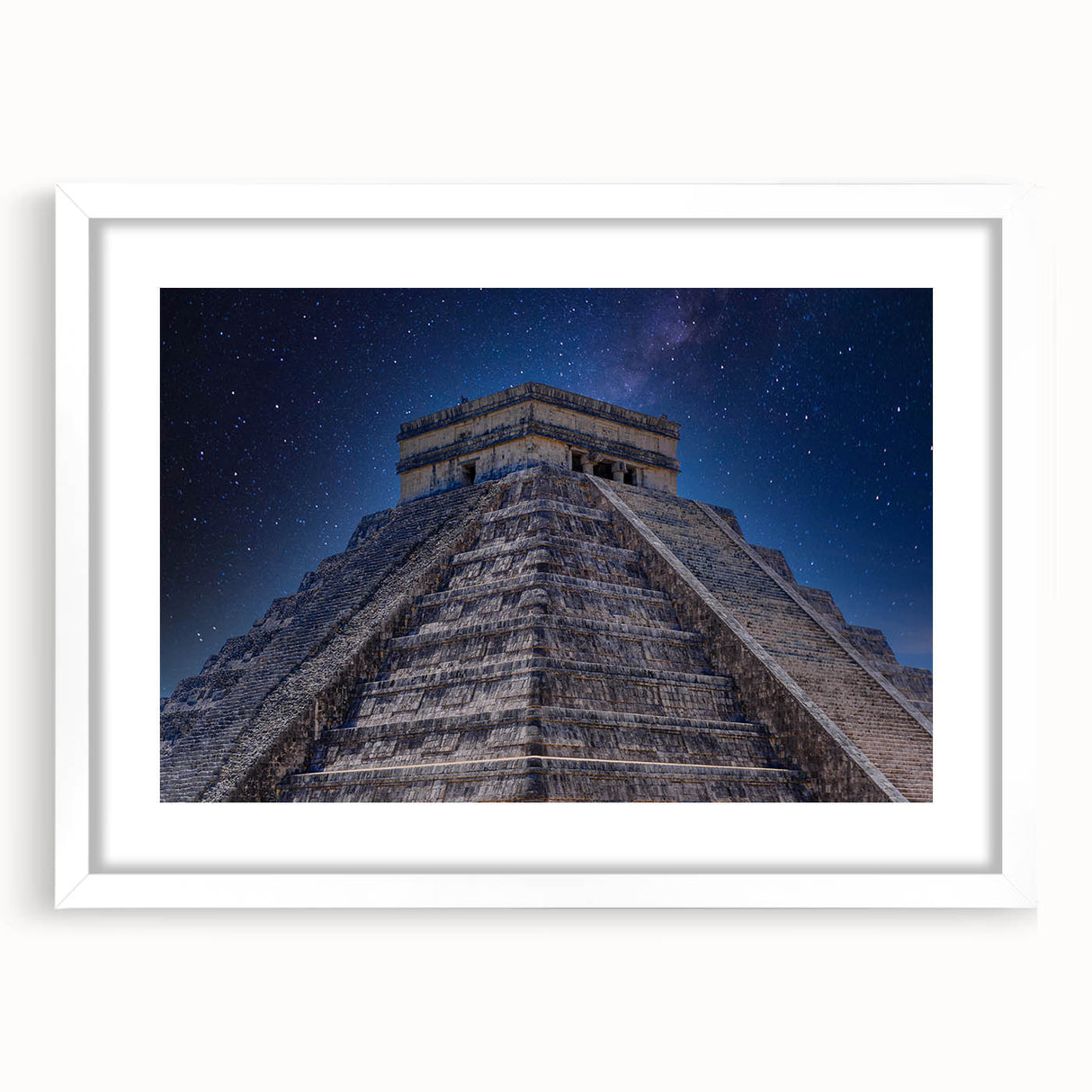 Abstract art print of a Central American scenery in muted earth tones, framed with a white mat.