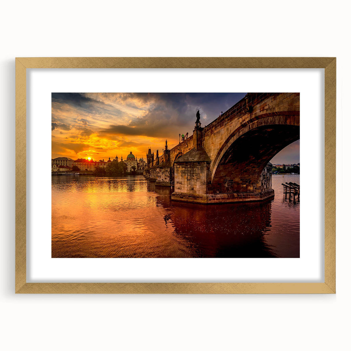 Abstract art print of Prague scenery in muted gold and blue tones, framed with a golden mat.