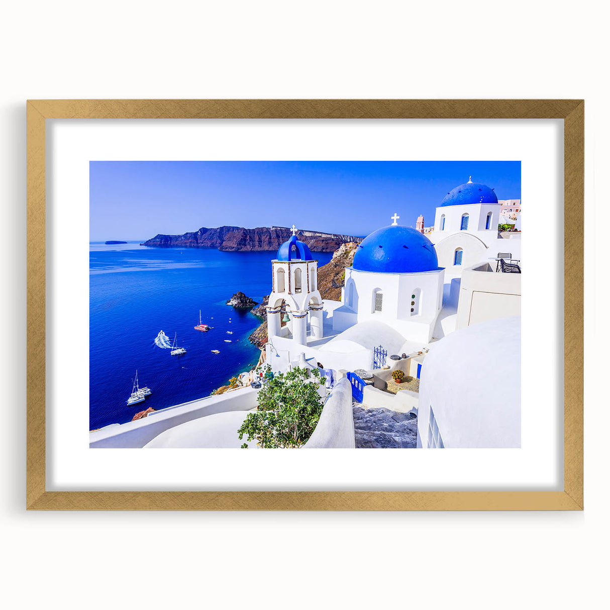 Abstract art print of Santorini with blue and white hues on a framed gold mat, ideal for dining room decor.