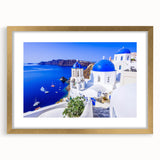 Abstract art print of Santorini with blue and white hues on a framed gold mat, ideal for dining room decor.