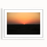 Abstract art print of a Middle Eastern landscape in muted earth tones on a framed white mat, ideal for dining room decor.