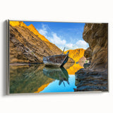 Framed canvas depicting a colorful Middle Eastern landscape with vibrant blue and orange tones, ideal for living room decor.