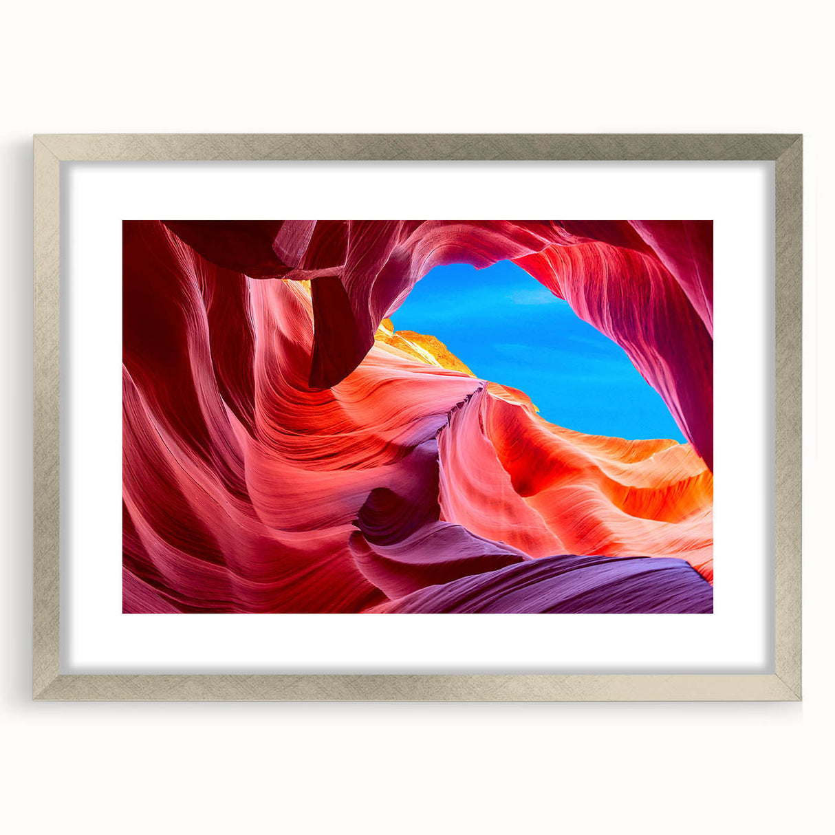 Textured abstract art print depicting Arizona's Antelope Canyon in earthy red and orange tones, framed in silver.