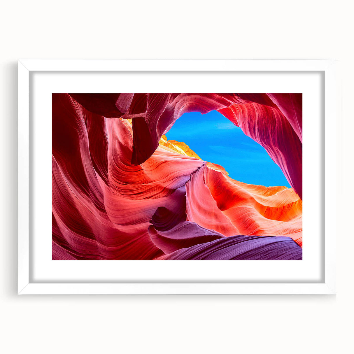 Abstract art print of Antelope Canyon in Arizona, with vibrant orange and red tones on a white framed canvas.