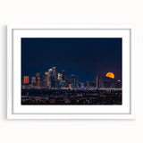 Abstract art print of Los Angeles skyline in muted gray and blue tones on a framed white mat, ideal for dining room decor.