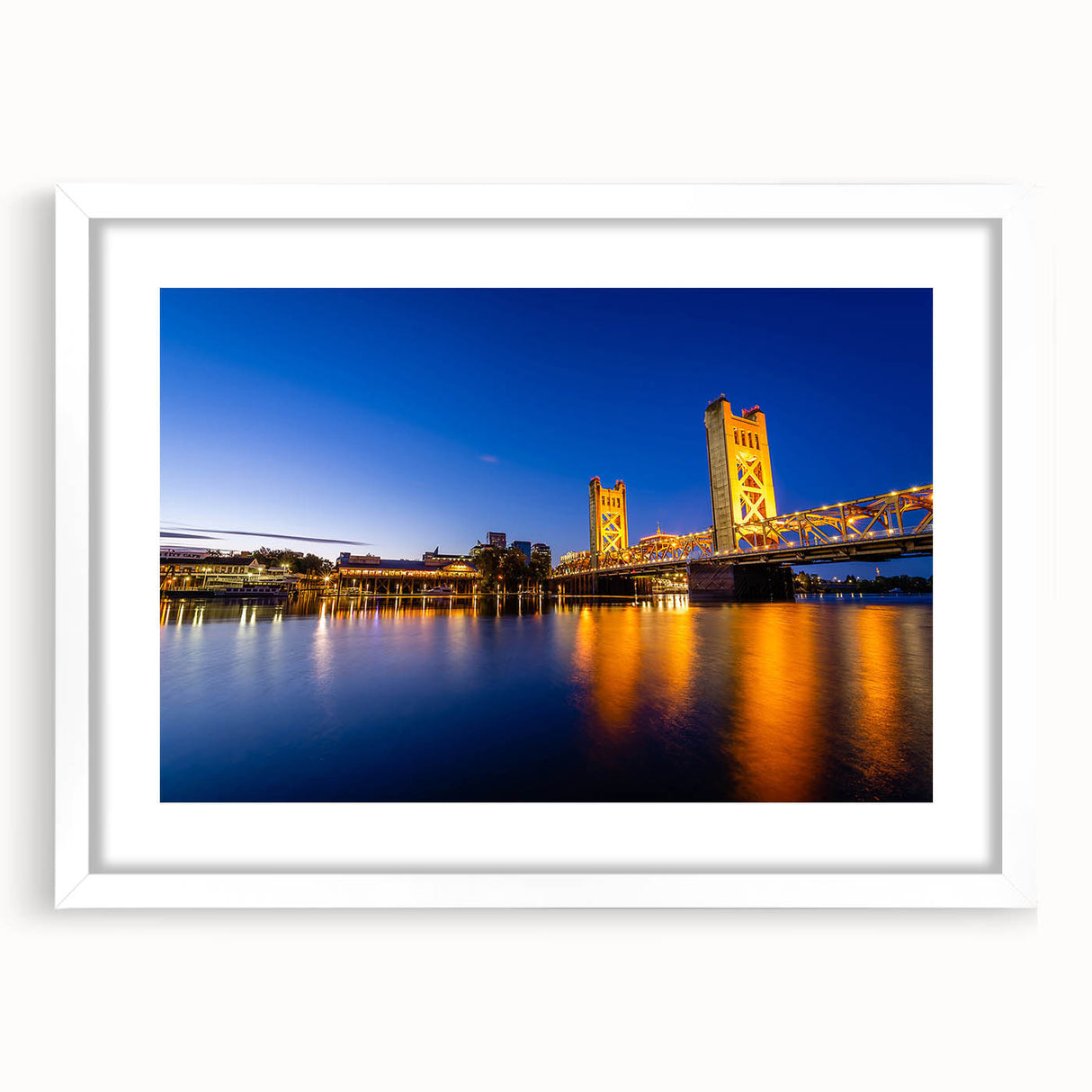 Abstract art print of Sacramento skyline in muted gray and blue tones on a framed white mat, ideal for dining room decor.