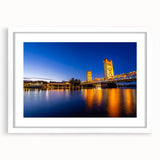 Abstract art print of Sacramento skyline in muted gray and blue tones on a framed white mat, ideal for dining room decor.