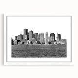 Abstract art print of Boston skyline in muted blue and grey tones on a framed white mat, ideal for dining room decor.