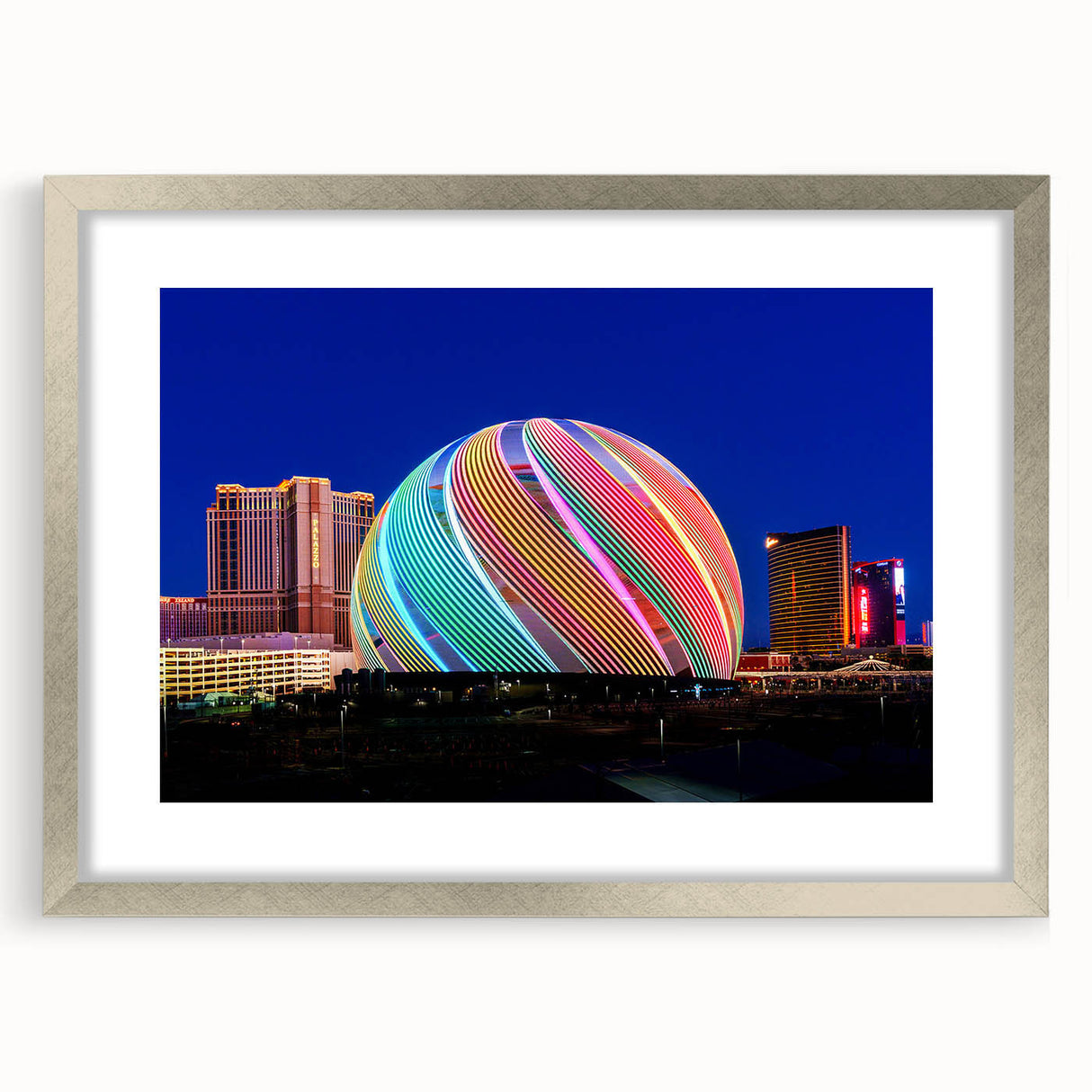 Textured abstract art print of Las Vegas scenery in muted earth tones, framed in silver, suitable for bedroom decor.