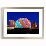 Textured abstract art print of Las Vegas scenery in muted earth tones, framed in silver, suitable for bedroom decor.