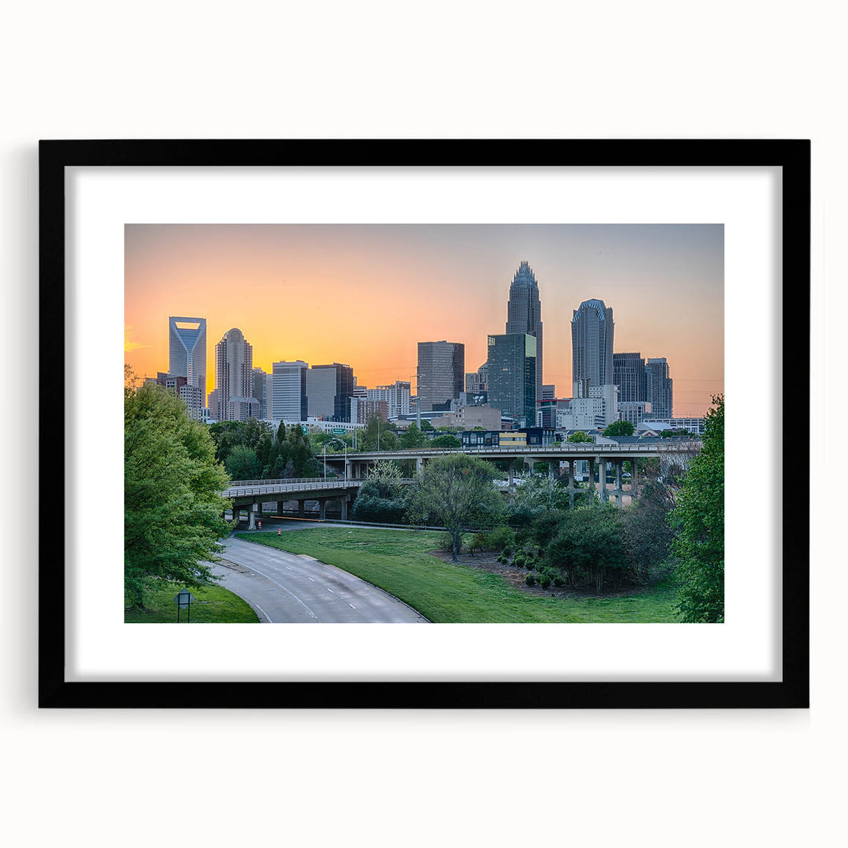 Extra large textured abstract art print of Charlotte skyline in vibrant colors on a black framed canvas.