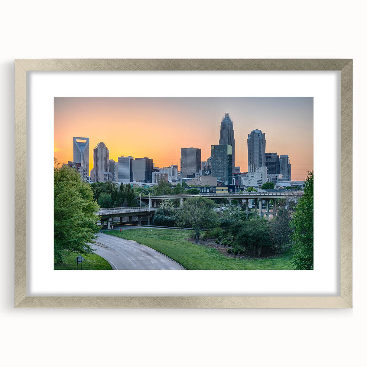 Textured abstract art print of Charlotte skyline in muted gray and blue tones on a framed silver mat.