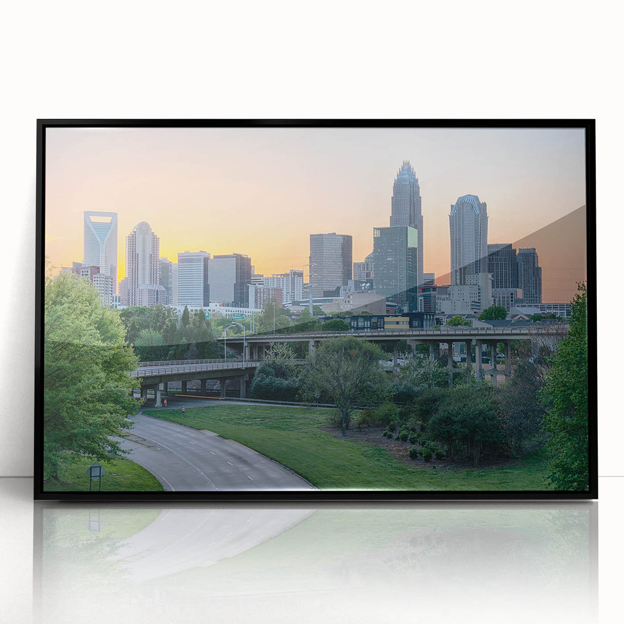 Large abstract wall art featuring a vibrant Charlotte skyline in acrylic, framed in black.
