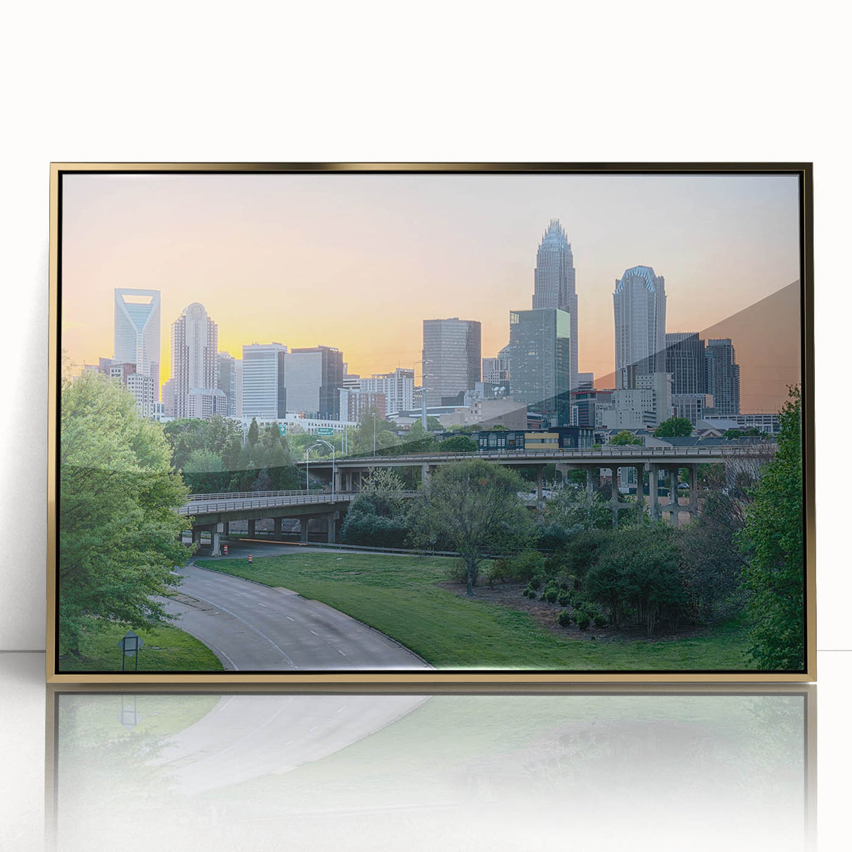 Acrylic print of Charlotte skyline in gold and blue tones, framed in mid-century modern style, suitable for nursery wall art.