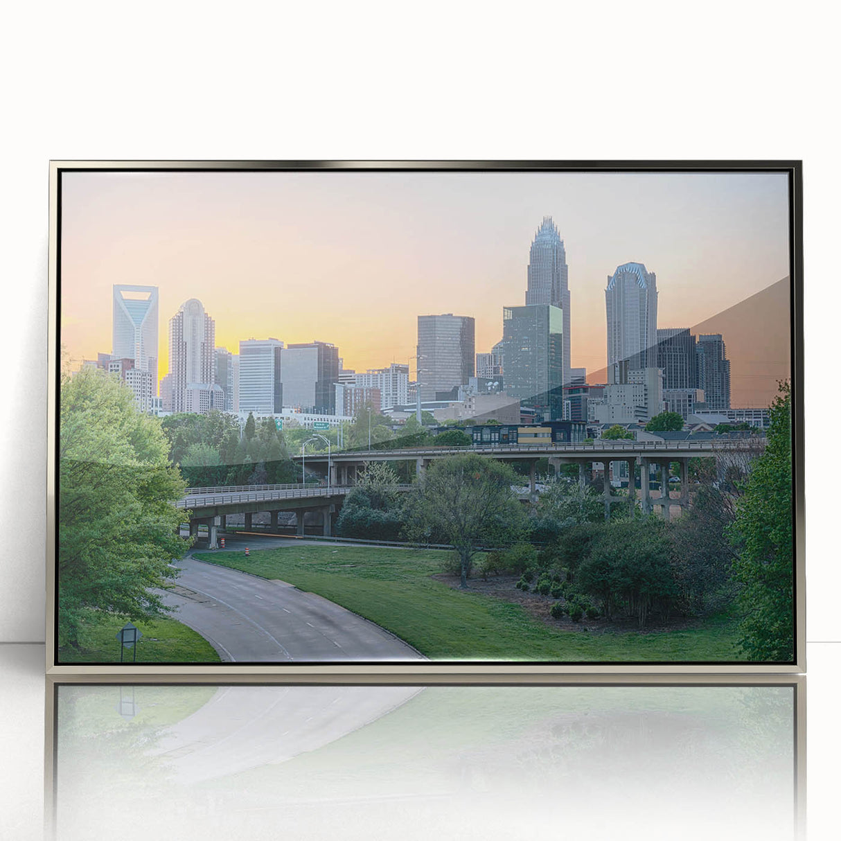 Mid-century modernist art depicting the Charlotte skyline in muted gray and blue tones on a framed acrylic print.