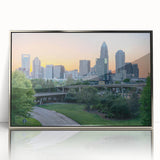 Mid-century modernist art depicting the Charlotte skyline in muted gray and blue tones on a framed acrylic print.