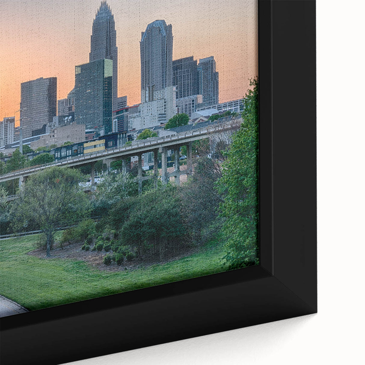 Extra large framed canvas featuring a textured depiction of the Charlotte skyline in black with colorful highlights.