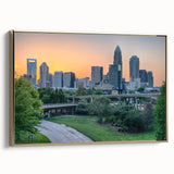 Framed canvas depicting a vintage-style Charlotte skyline in muted gold and black tones, ideal for bedroom wall art.