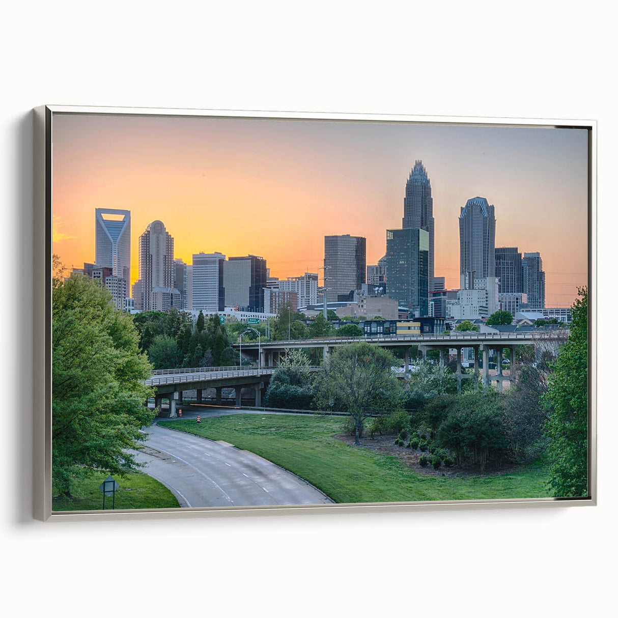 Framed canvas of a vintage-style Charlotte, North Carolina skyline in muted colors, ideal for office decor.