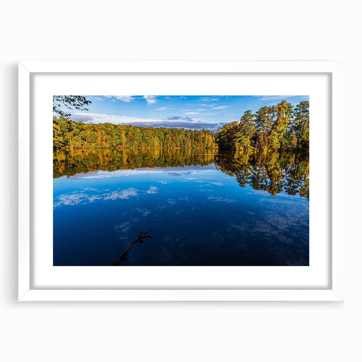 Abstract art print of Raleigh skyline in muted gray and blue tones on a framed white mat, suitable for dining room decor.