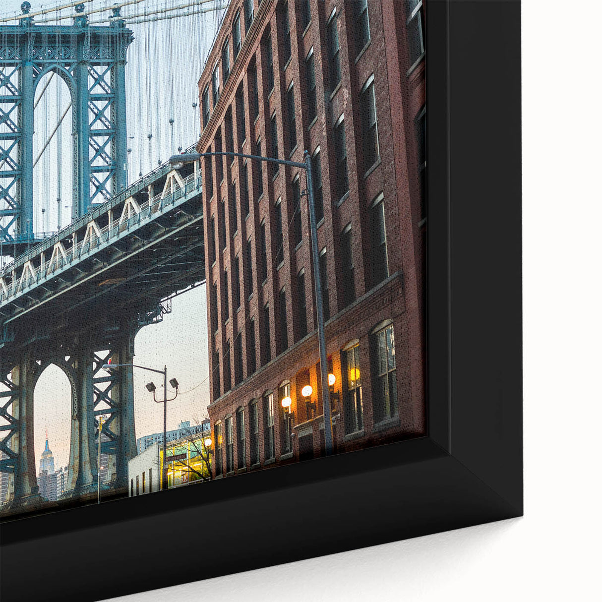 Close-up of a framed canvas featuring a textured depiction of the Brooklyn Bridge in black with colorful accents.