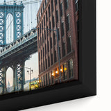 Close-up of a framed canvas featuring a textured depiction of the Brooklyn Bridge in black with colorful accents.