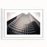Abstract art print of Seattle skyline in muted gray and blue tones, framed with a white mat, ideal for dining room decor.
