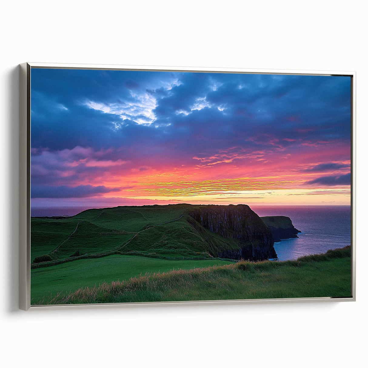 Framed canvas artwork depicting a serene landscape with cliffs, featuring a silver frame and showcasing intricate details and vibrant colors. Ideal for modern home decor.