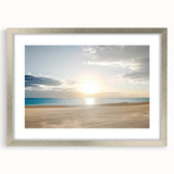 Silver-framed landscape artwork showcasing serene beach scenery, elegantly matted for display. Ideal for home decor, highlighting coastal themes and tranquility.