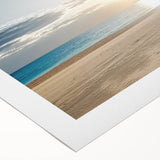 Vibrant rolled canvas showcasing a serene beach landscape with soft waves and golden sand, expertly packaged in a durable cardboard tube for safe delivery.