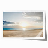 Vibrant rolled print depicting a serene beach landscape, showcasing soft sand and gentle waves under a bright blue sky, packaged securely in a protective tube.