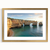 Framed landscape artwork depicting majestic cliffs, featuring a gold mat and frame, ideal for home decor enthusiasts seeking elegant wall accents.