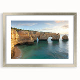 Framed landscape artwork showcasing dramatic cliffs in a silver frame with a mat, highlighting intricate details and vibrant colors, perfect for home decor.