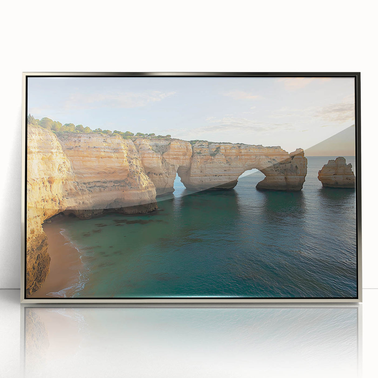 Framed acrylic artwork depicting a stunning cliff landscape in silver tones, highlighting dramatic rock formations under a clear sky, perfect for modern home decor.