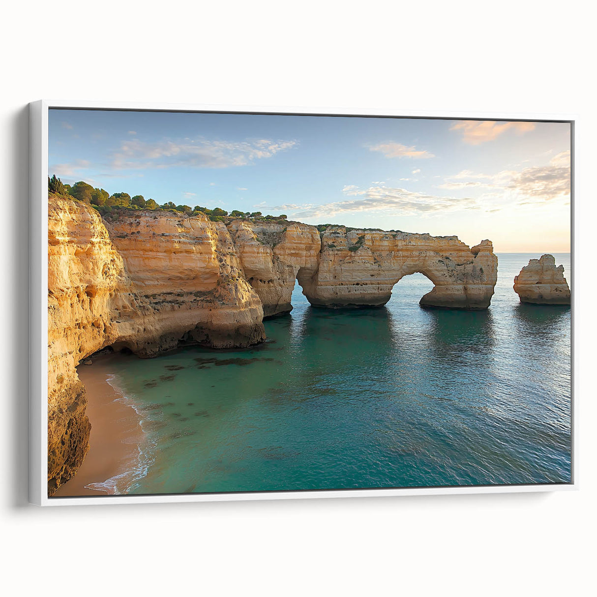 Framed canvas artwork depicting a scenic landscape of cliffs with a vibrant blue sky, showcasing natural beauty and ideal for home decor. The white frame enhances the visual appeal.