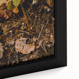 Close-up of a framed canvas featuring textured, colorful art with black background depicting autumn leaves.