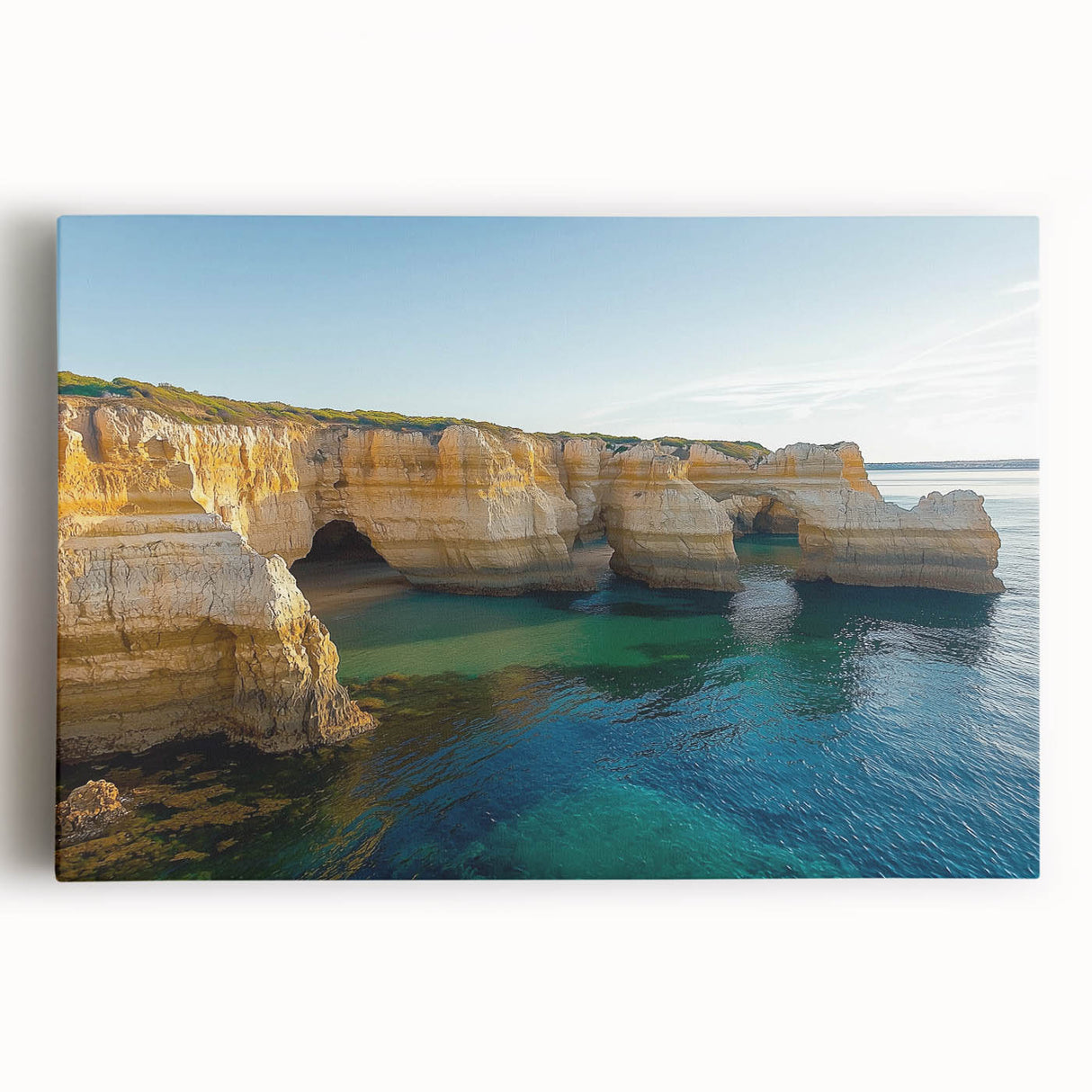 Stretched canvas artwork depicting a vibrant landscape with dramatic cliffs under a clear blue sky, perfect for enhancing modern home decor.