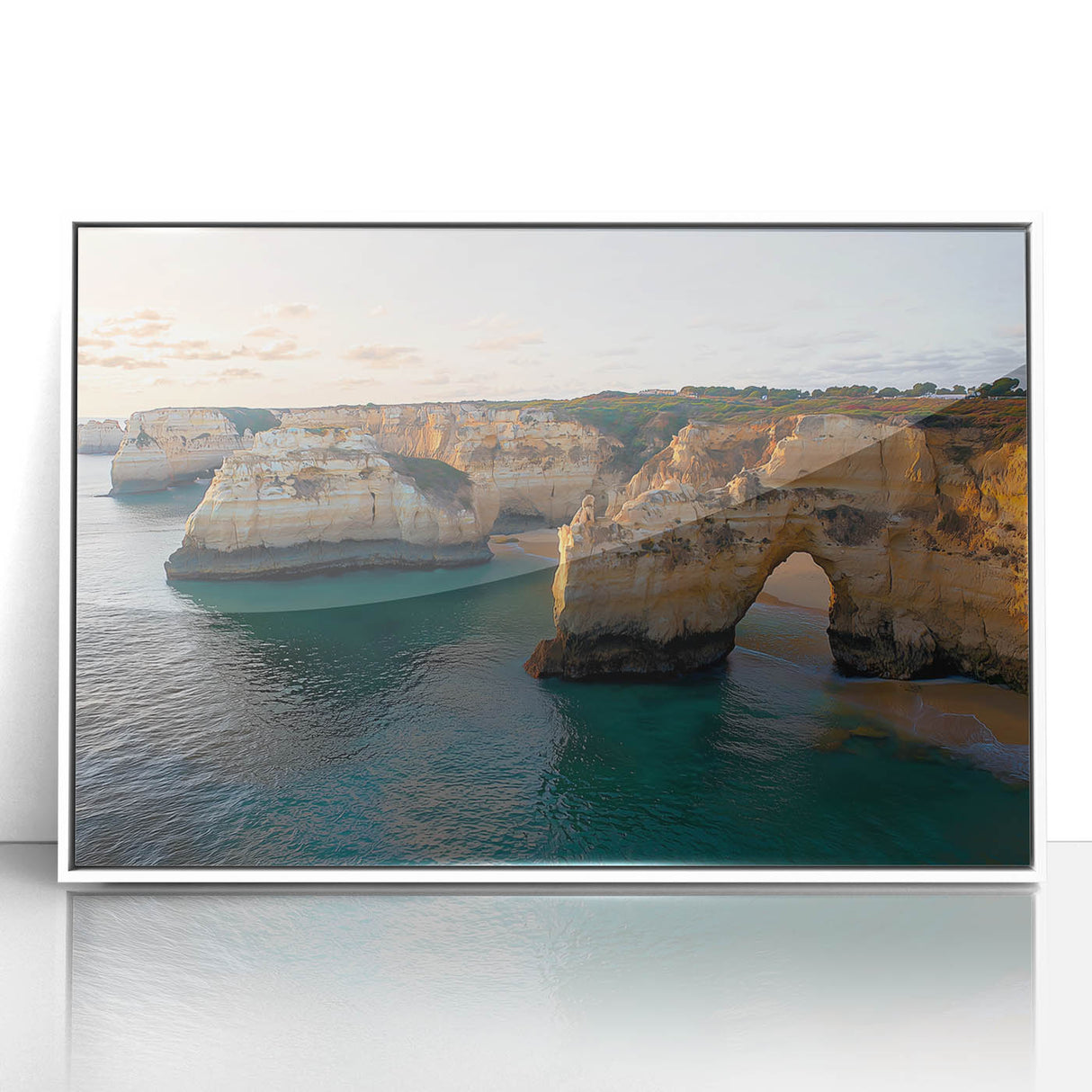 Framed acrylic landscape artwork showcasing dramatic cliffs and serene ocean views, set against a bright white frame, perfect for modern home decor.